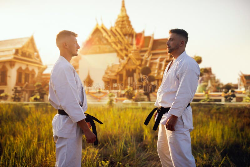 Karate Fighters In Kimono Against Ancient Temple Stock Photo - Image of